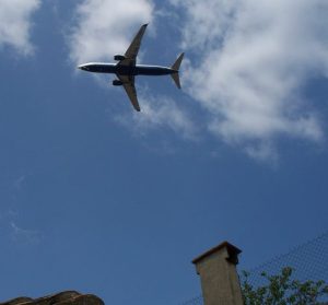 Plane over rooftops